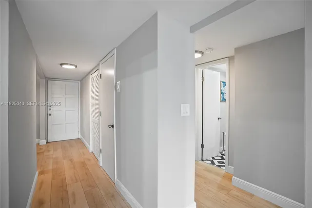 a view of a hallway with wooden floor