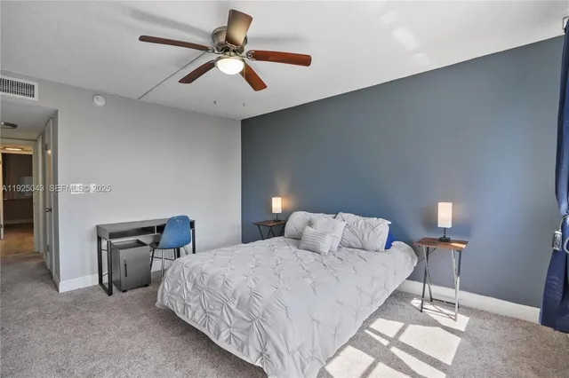 a bedroom with a bed and a lamp