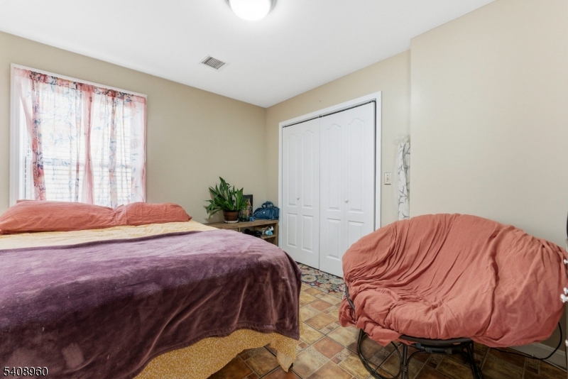 29 22nd Avenue Paterson, NJ 07513 - Photo 13 of 20 a bedroom with a bed and closet