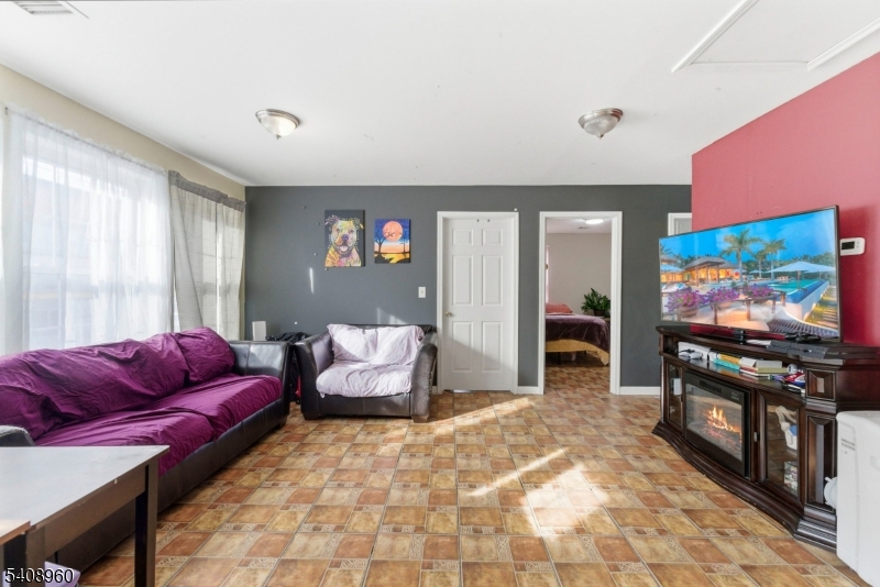 29 22nd Avenue Paterson, NJ 07513 - Photo 15 of 20 a living room with furniture and a flat screen tv