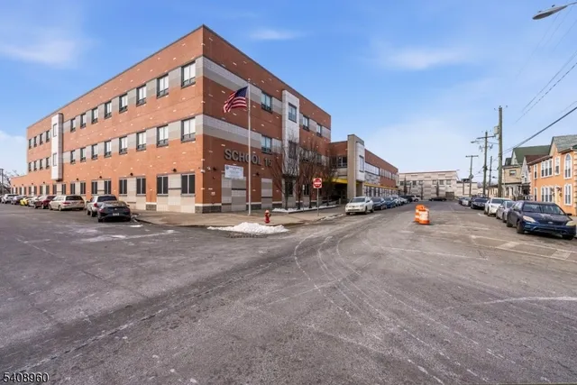 a view of building with cars parked