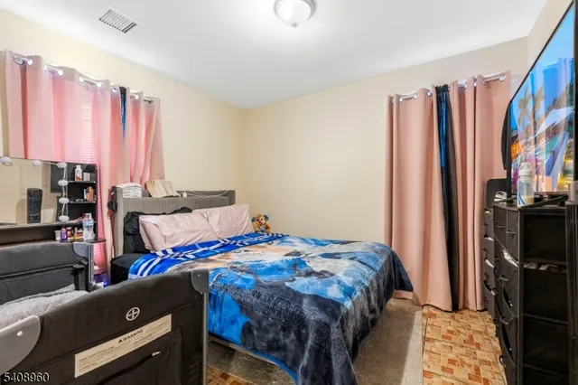 a bedroom with a bed a dresser and a book shelf