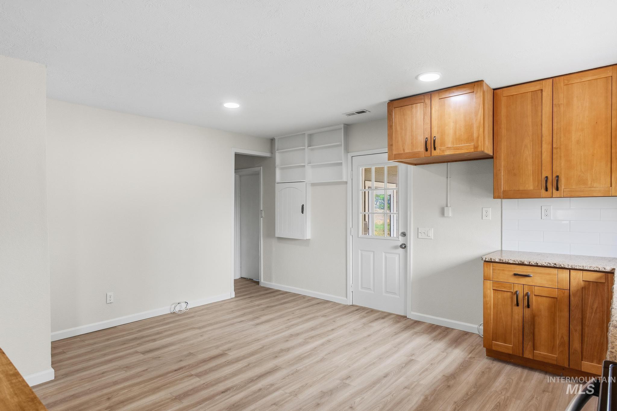 14666 Willis Road Caldwell, ID 83607 - Photo 20 of 50 Kitchen area featuring light wood-finish flooring, recessed lighting, and perimeter kitchen cabinetry with a light-colored countertop