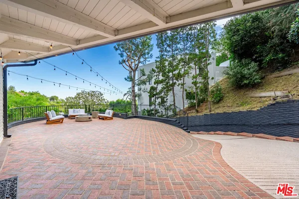 a dining room with furniture a chandelier and wooden floor