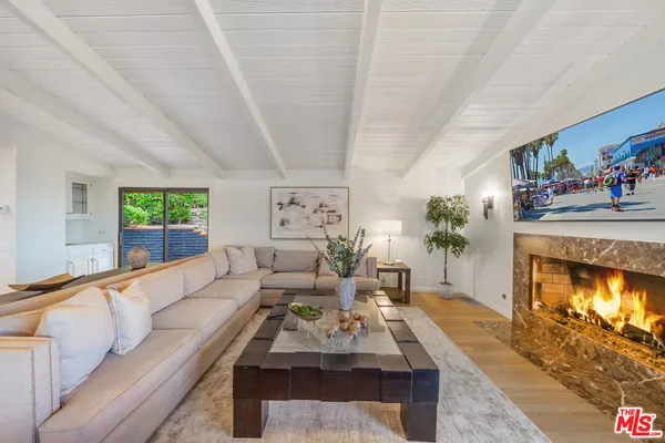 a bedroom with a bed a couch and a fireplace