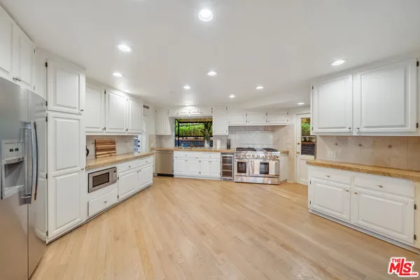 a bathroom with a granite countertop sink mirror and shower