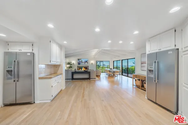 a view of a livingroom with wooden floor and window