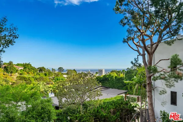 a bedroom with a bed and glass door