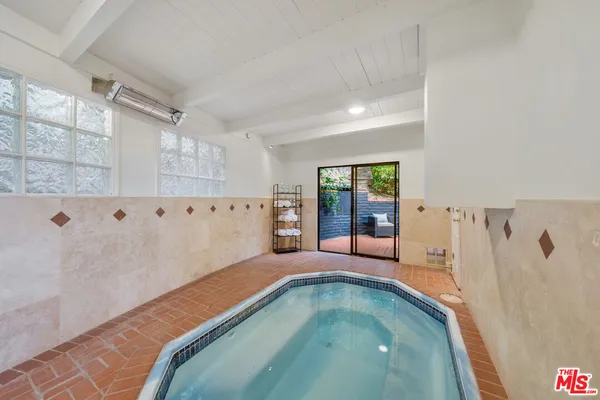 a spacious bedroom with a bed and a flat screen tv