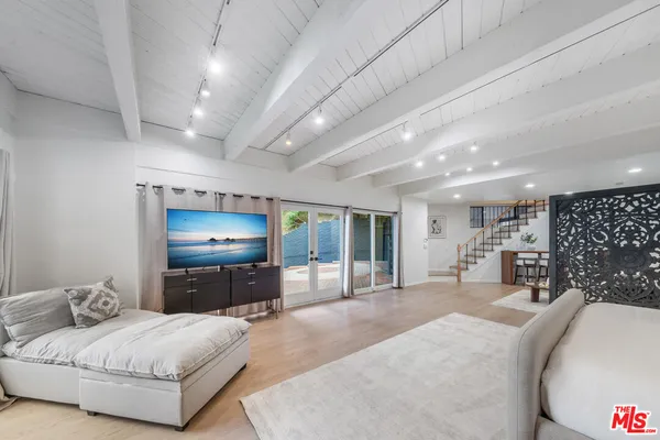 a view of a house with a small yard and furniture