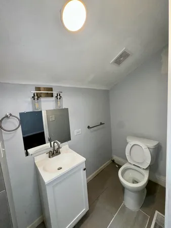 a view of bathroom with a toilet and a sink