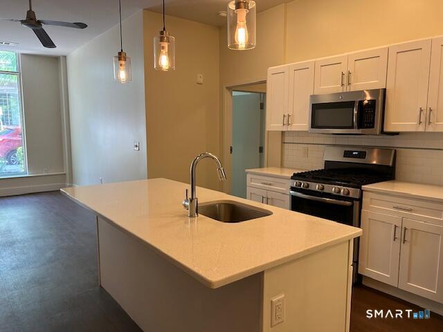 111 Morgan Street, Unit TH5 Stamford, CT 06905 - Photo 4 of 23 a kitchen with a sink a stove and a microwave