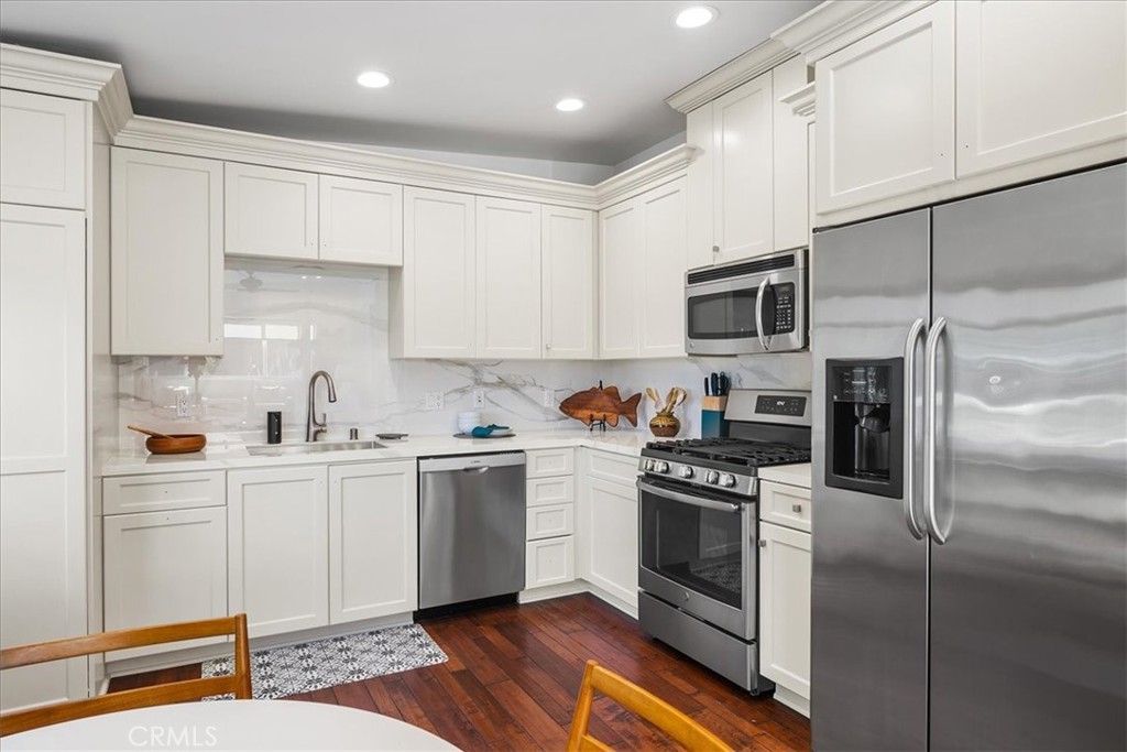 737 Griffith Way Laguna Beach, CA 92651 - Photo 5 of 22 a kitchen with white cabinets and stainless steel appliances