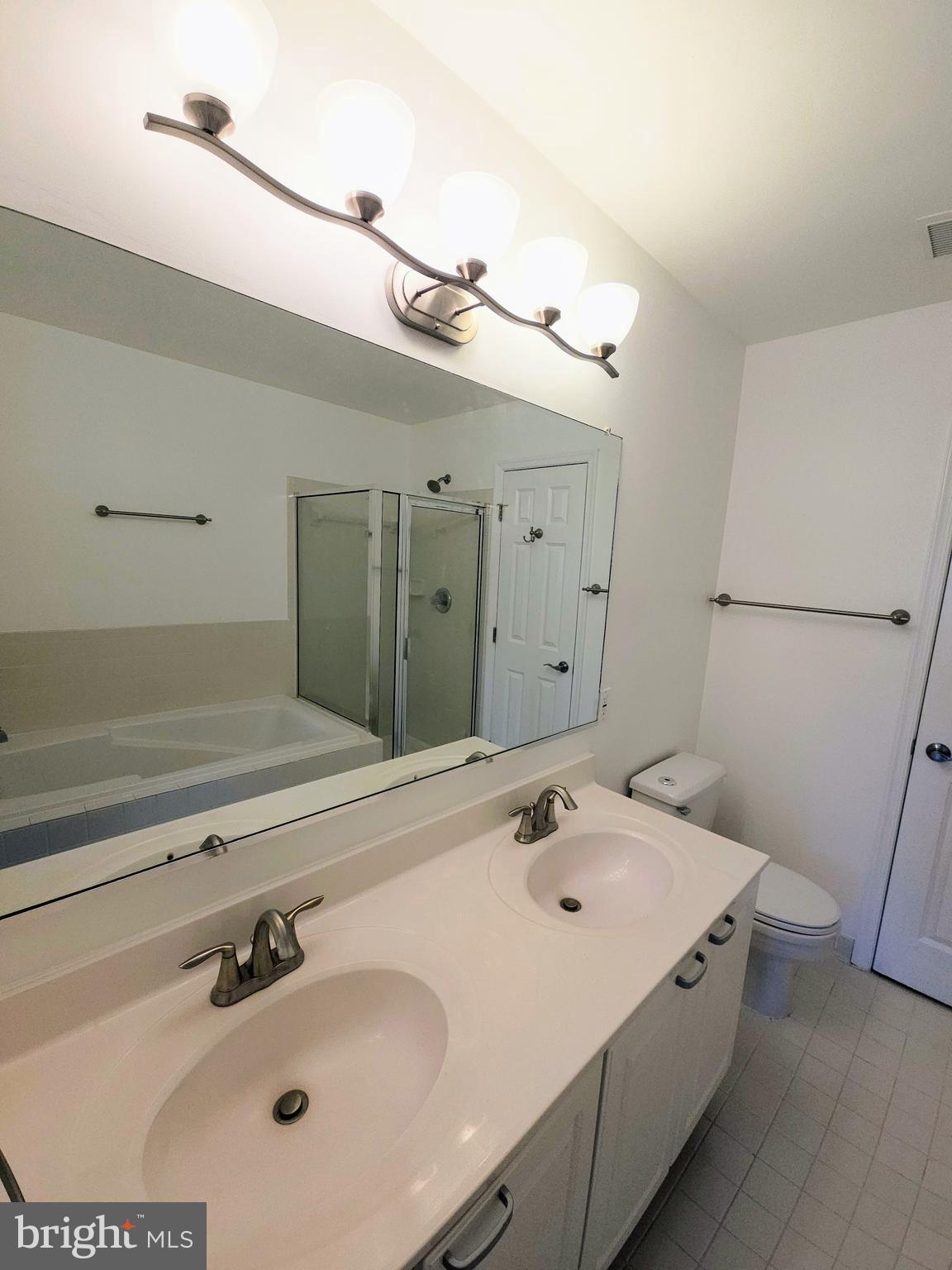 2014 Crosbyside Court Odenton, MD 21113 - Photo 29 of 58 a bathroom with a sink and a mirror