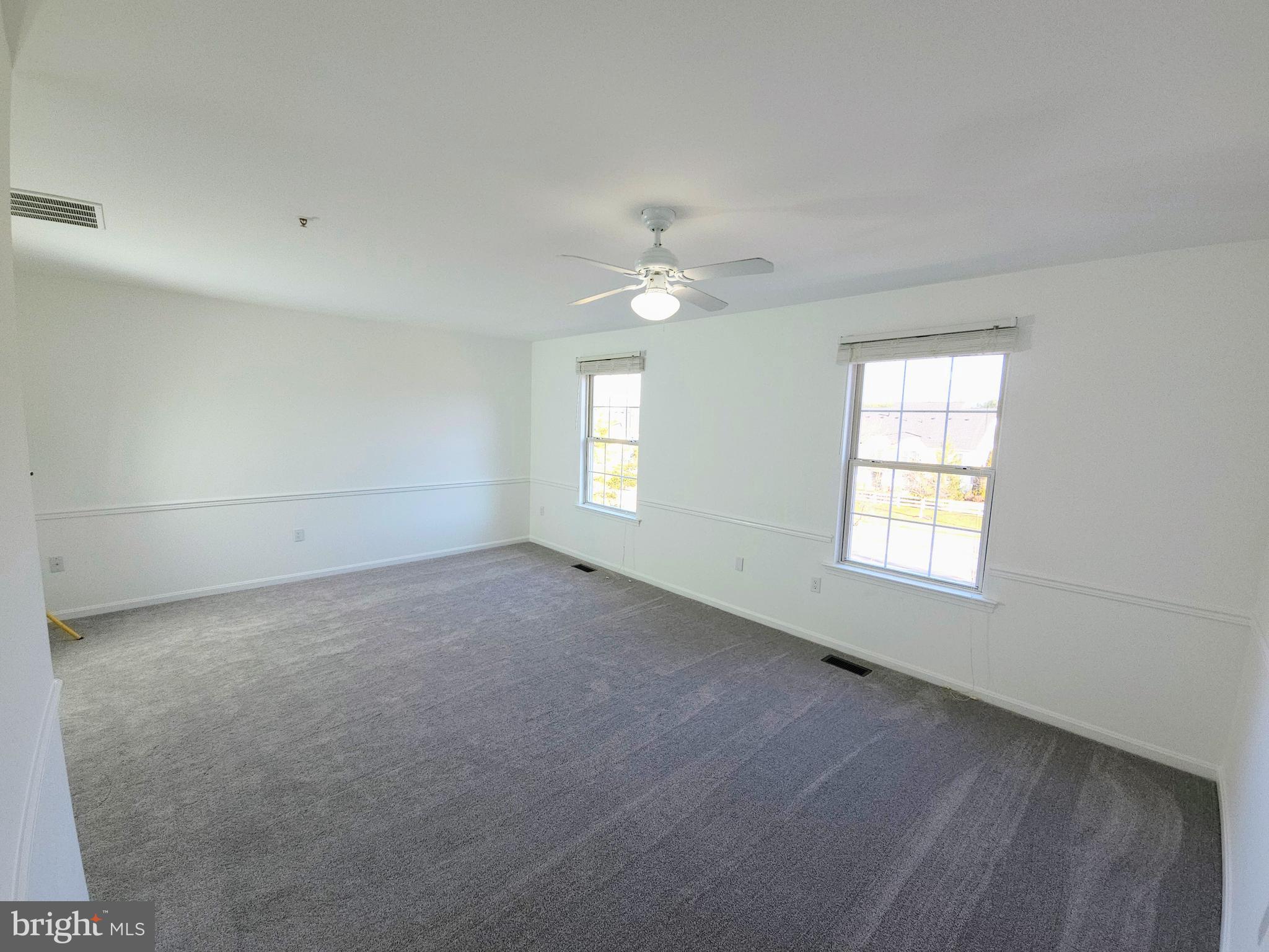 2014 Crosbyside Court Odenton, MD 21113 - Photo 32 of 58 an empty room with windows and ceiling fan