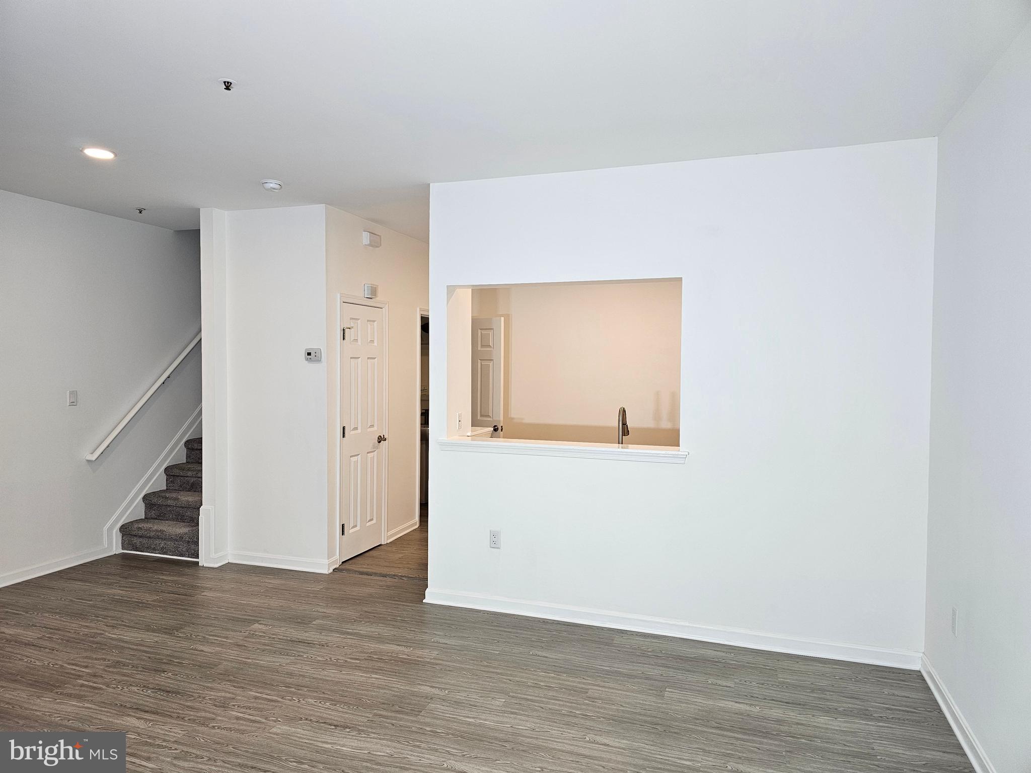 2014 Crosbyside Court Odenton, MD 21113 - Photo 54 of 58 a view of an empty room with wooden floor and staircase