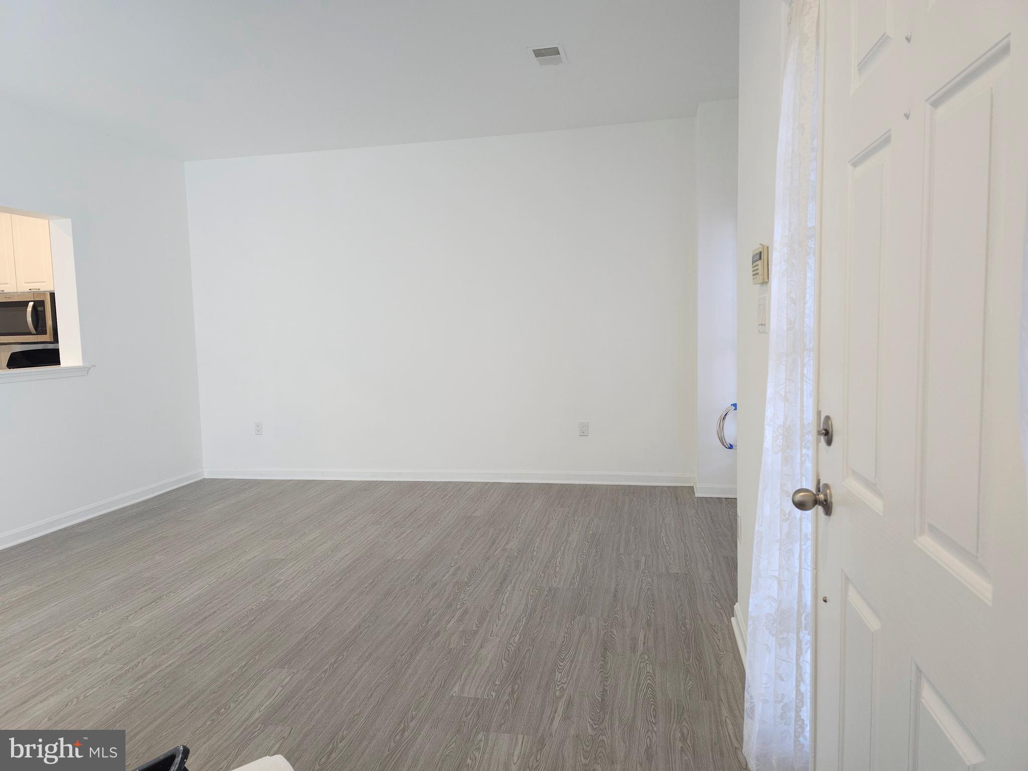 2014 Crosbyside Court Odenton, MD 21113 - Photo 55 of 58 an empty room with wooden floor and mirror