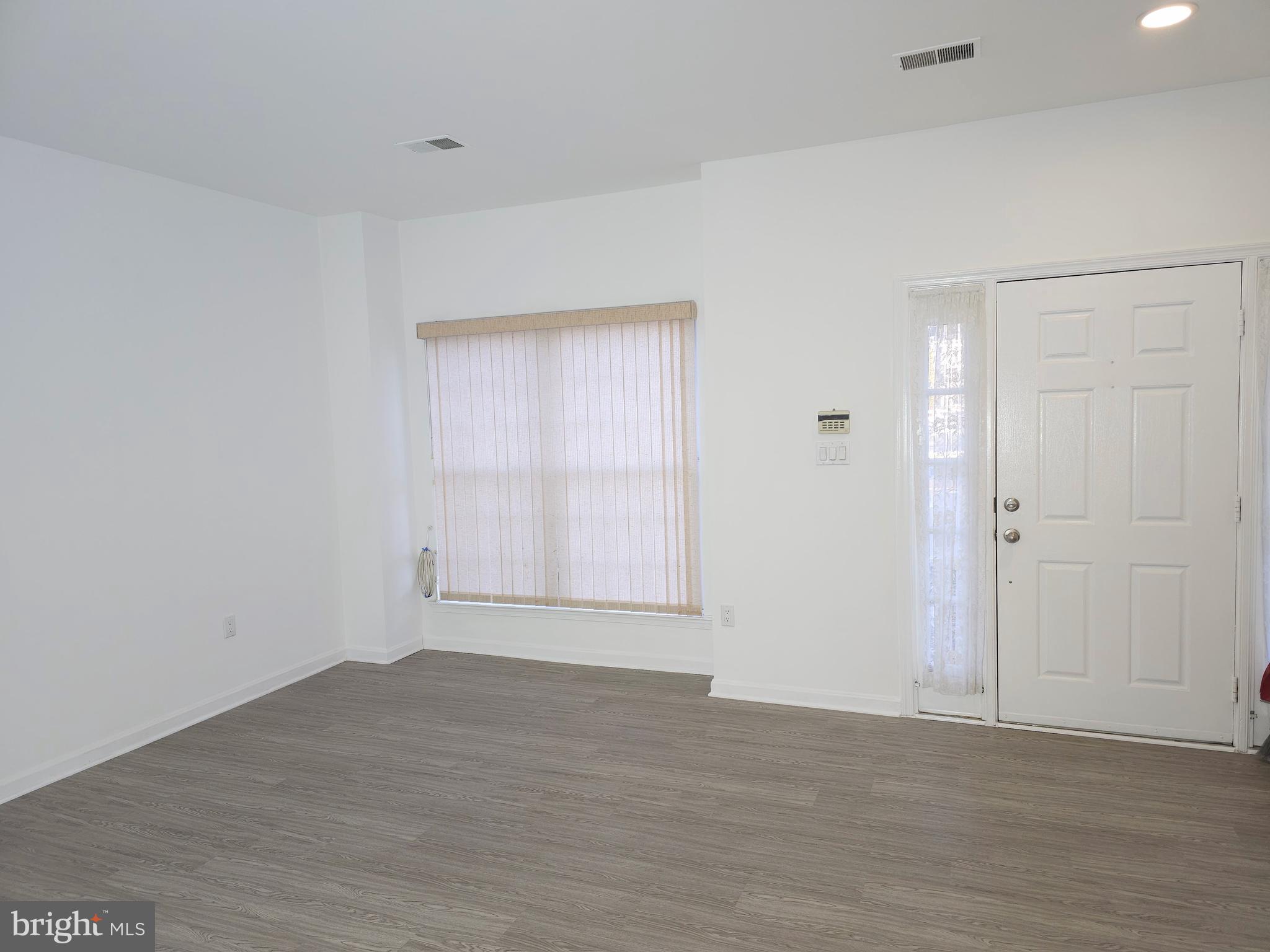 2014 Crosbyside Court Odenton, MD 21113 - Photo 6 of 58 a view of an empty room with wooden floor and a window