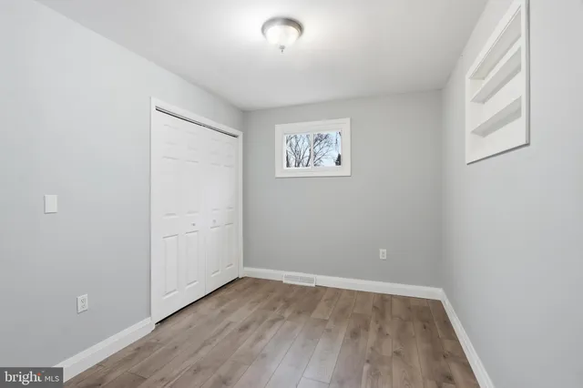 wooden floor in an empty room with a window