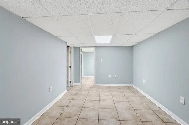 a view of a room with an empty space and a window