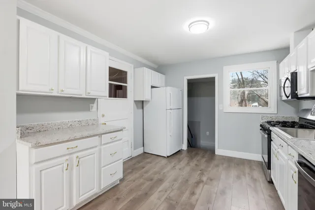 a kitchen with stainless steel appliances granite countertop a stove and a refrigerator