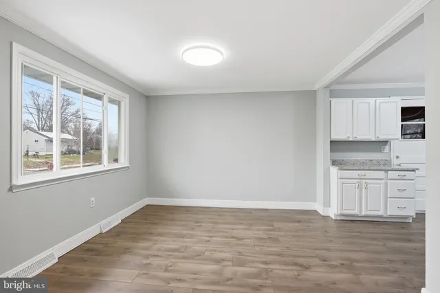 a view of a kitchen with granite countertop cabinets and wooden floor