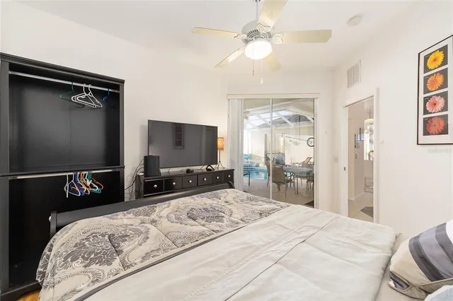 a bedroom with a bed a table and chair