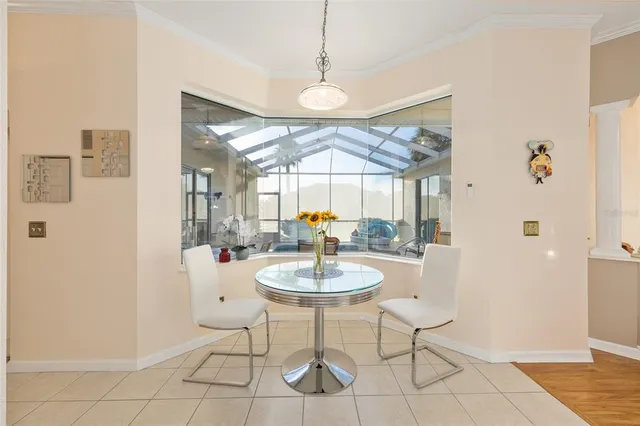 a view of a dining room with furniture large windows and wooden floor