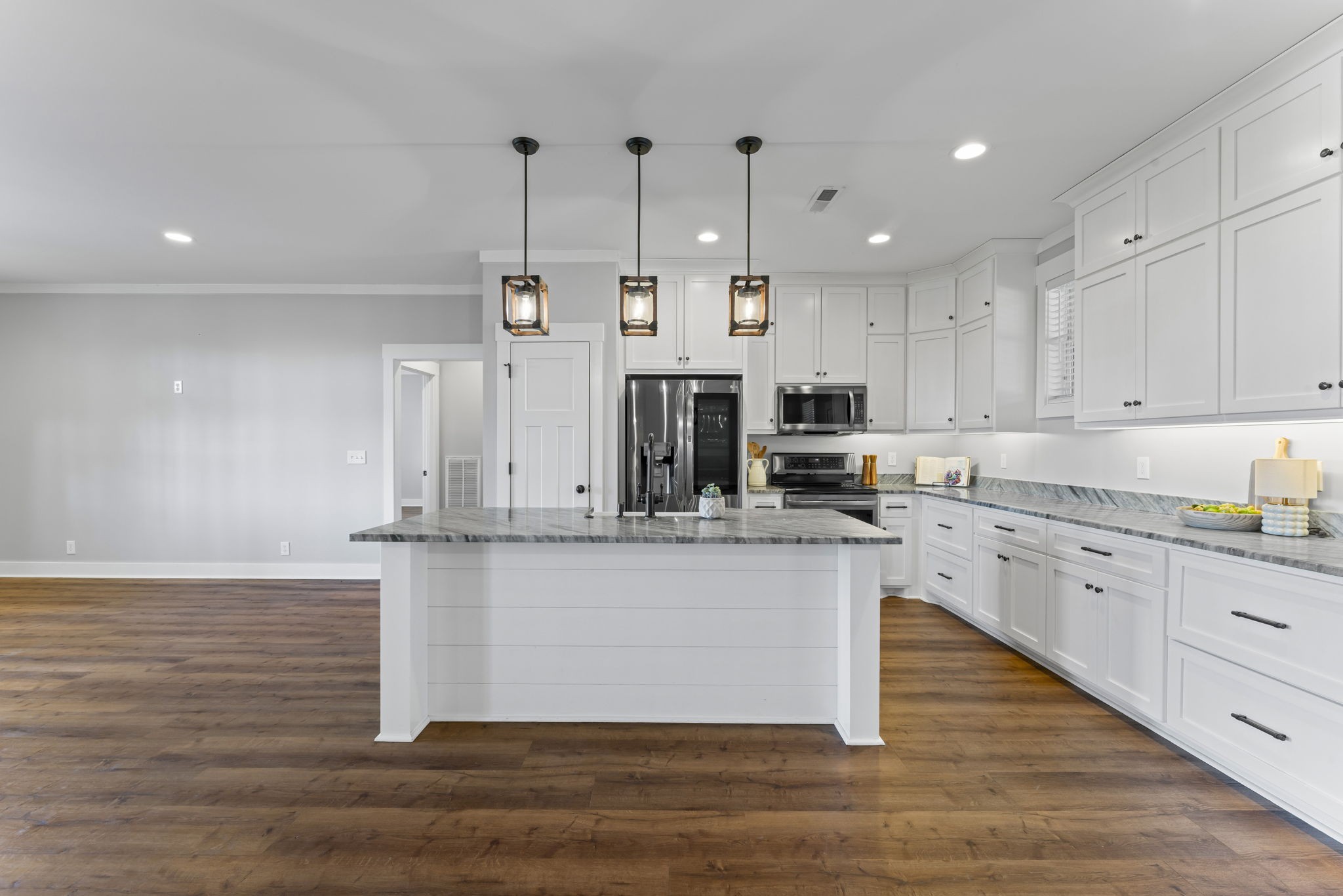 5706 Lunns Store Road Chapel Hill, TN 37034 - Photo 9 of 37 a kitchen with stainless steel appliances granite countertop a sink a stove a refrigerator and white cabinets with wooden floor