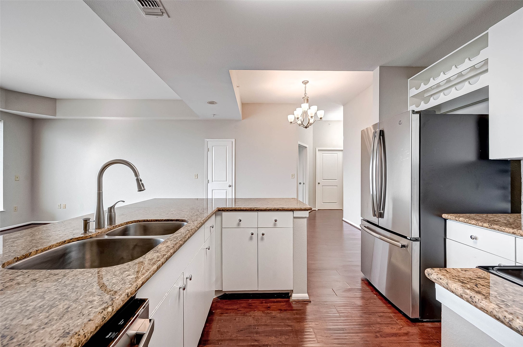 3505 Sage Road, Unit 2106 Houston, TX 77056 - Photo 11 of 28 a kitchen with a refrigerator sink and cabinets