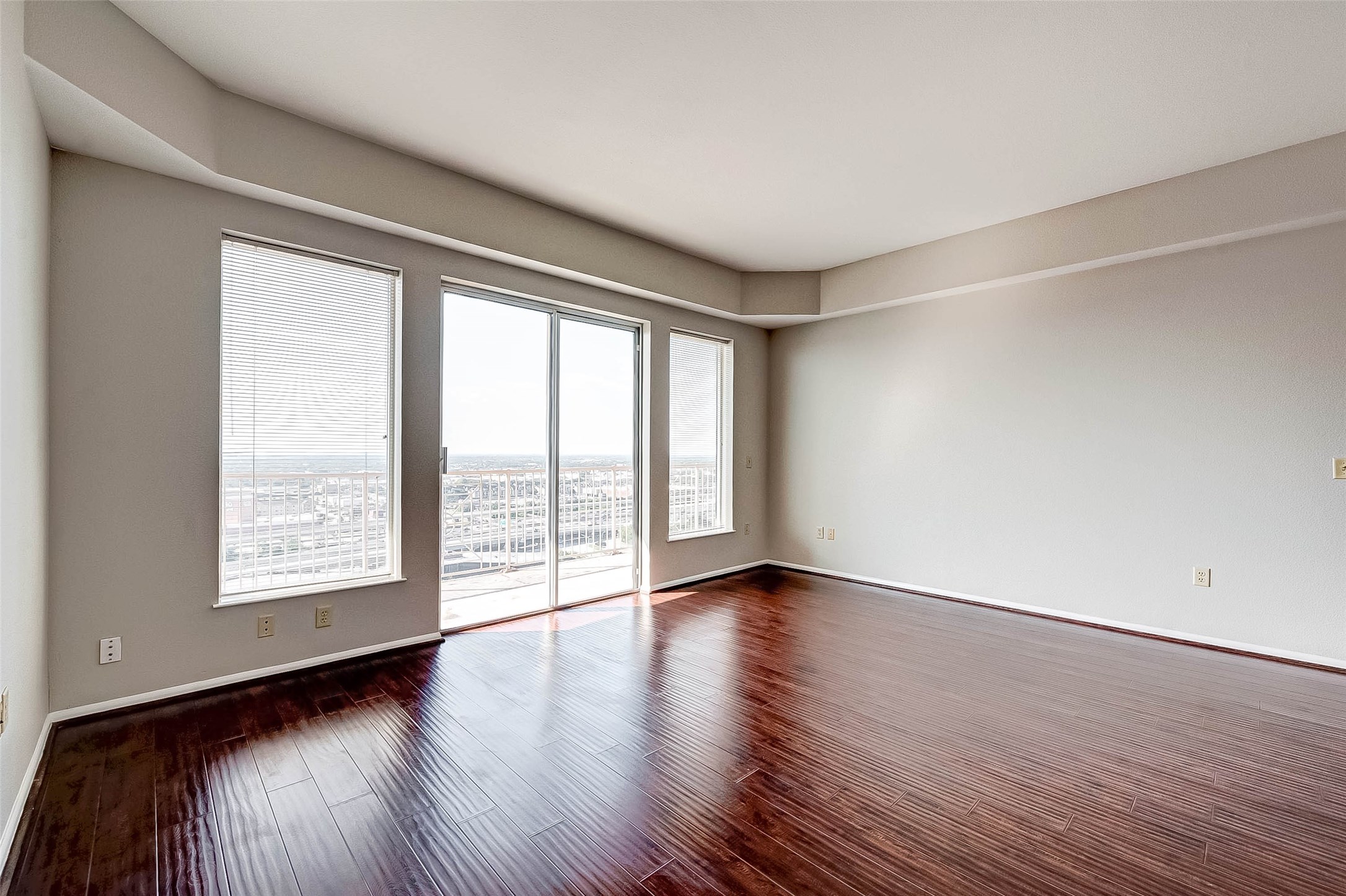 3505 Sage Road, Unit 2106 Houston, TX 77056 - Photo 9 of 28 a view of an empty room with wooden floor and a window