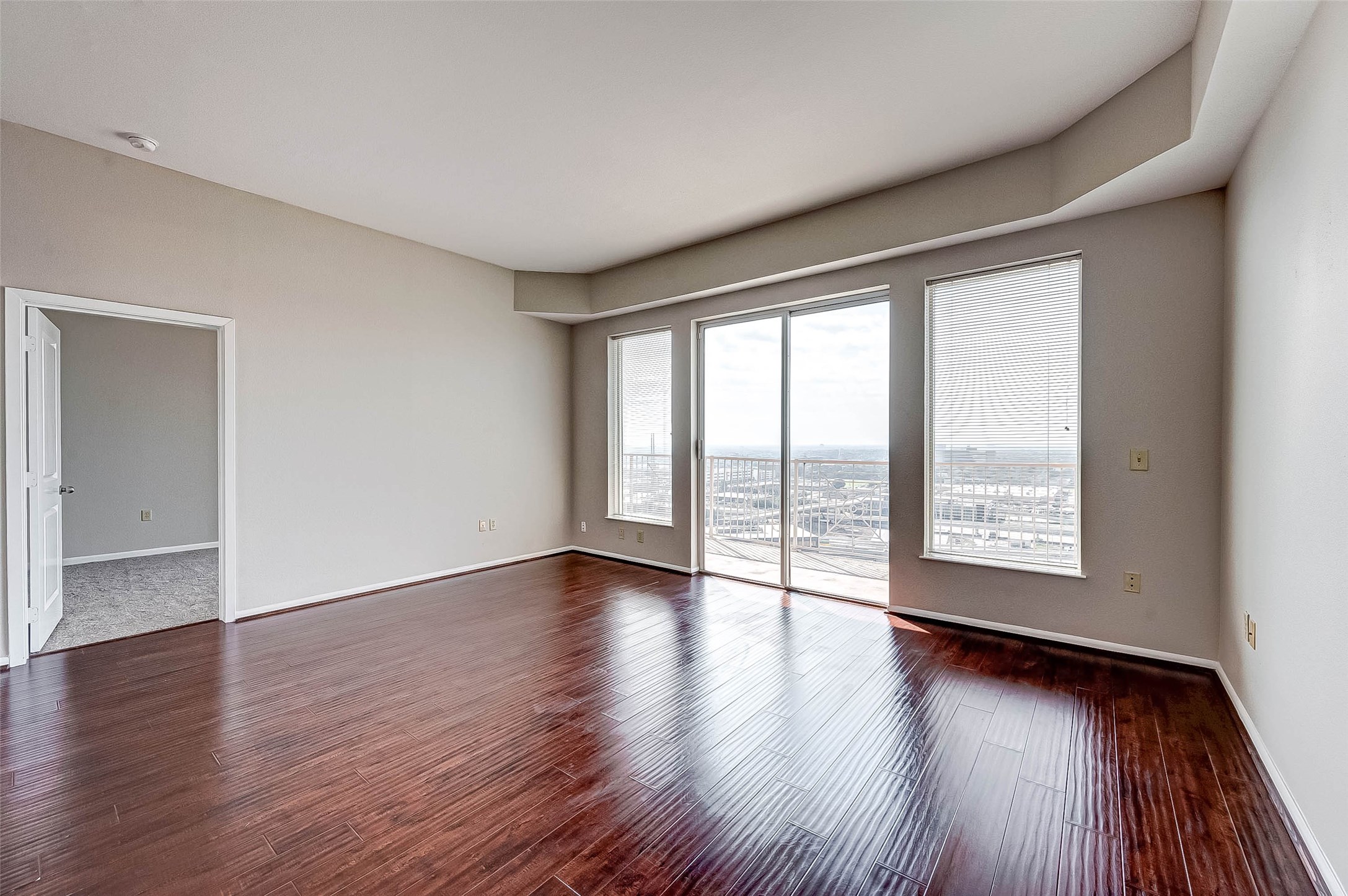 3505 Sage Road, Unit 2106 Houston, TX 77056 - Photo 10 of 28 a view of an empty room with wooden floor and a window