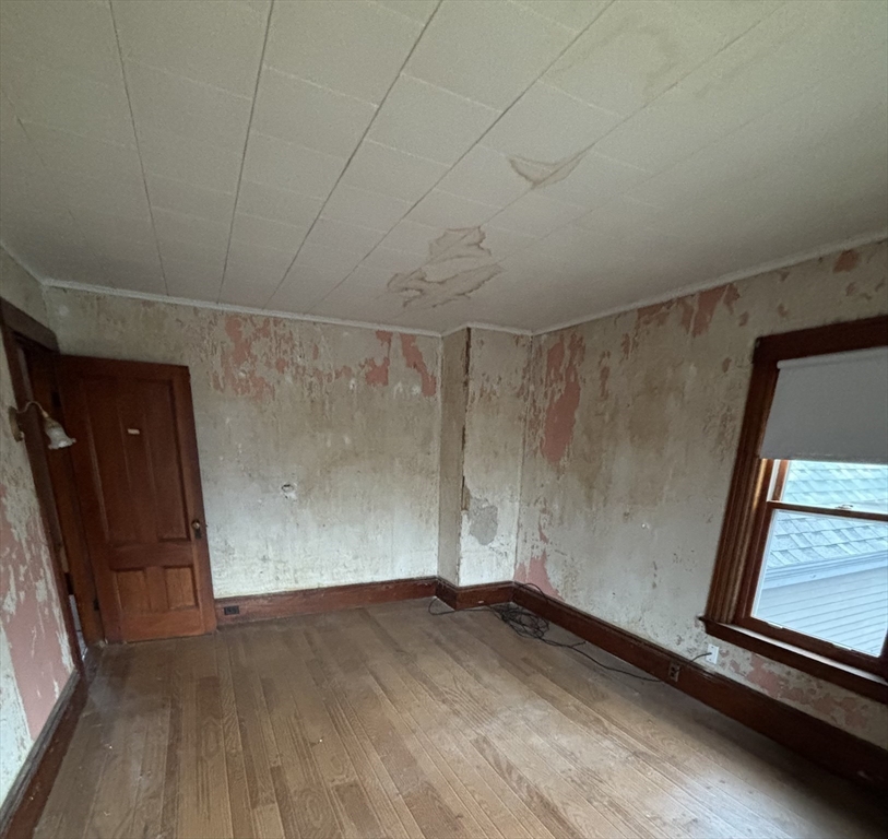316 Amesbury Road Haverhill, MA 01830 - Photo 18 of 28 a view of empty room with wooden floor and fan