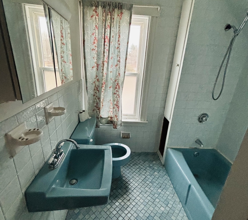 316 Amesbury Road Haverhill, MA 01830 - Photo 22 of 28 a bathroom with a sink a window and tub