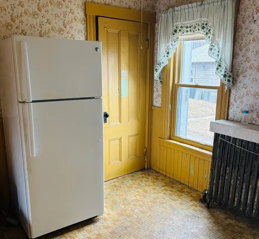 a view of a refrigerator in a kitchen