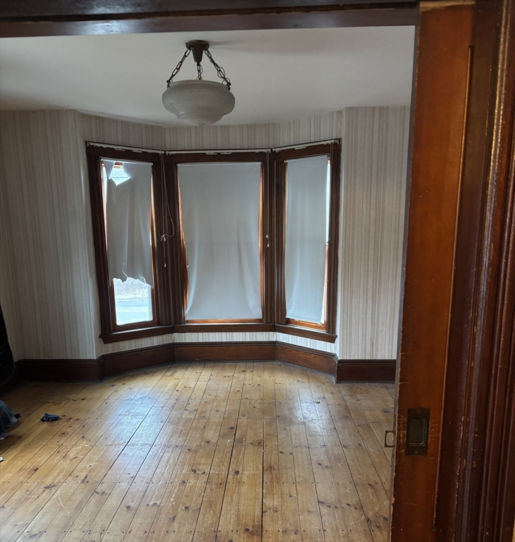 316 Amesbury Road Haverhill, MA 01830 - Photo 10 of 28 a view of an empty room with wooden floor and a window