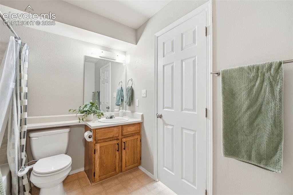 4357 Hunting Meadows Circle Colorado Springs, CO 80916 - Photo 11 of 20 a bathroom with a granite countertop sink toilet and shower