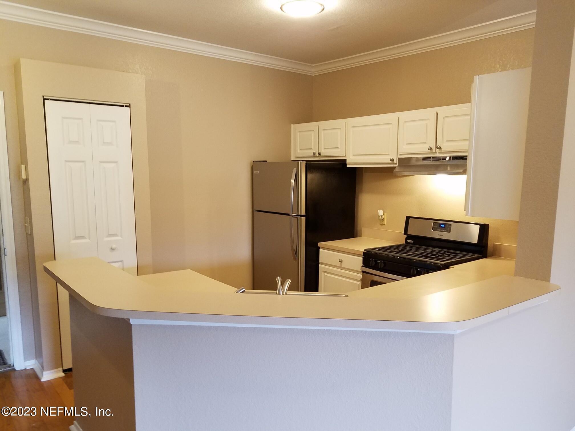 a kitchen with stainless steel appliances a refrigerator and a stove