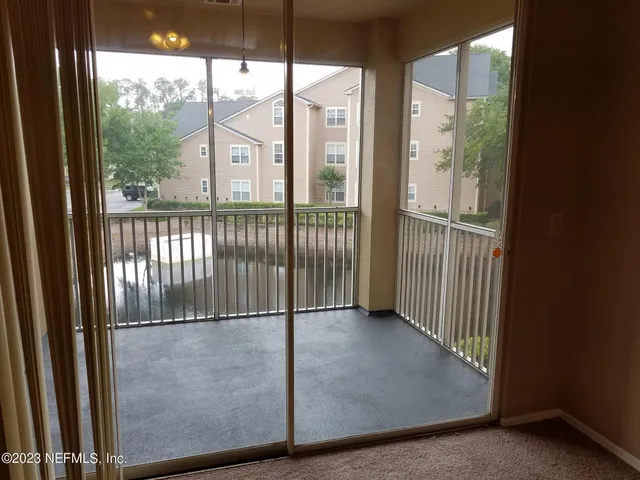 a view of a glass door with a yard from balcony