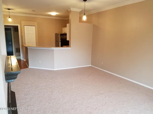 a view of a kitchen with a sink and a refrigerator