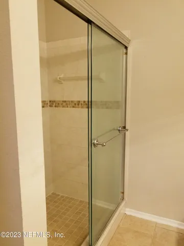 a bathroom with a glass shower door