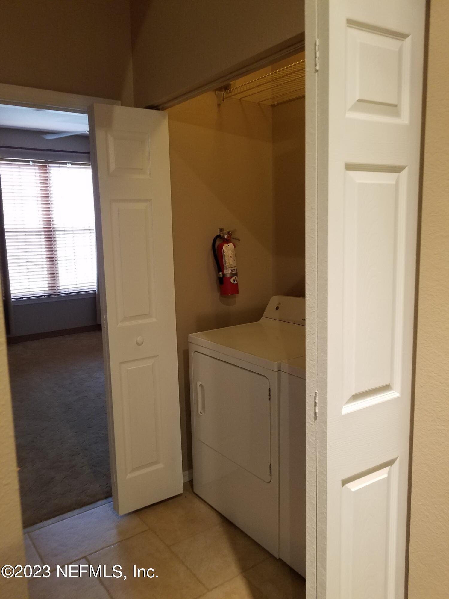 13810 Sutton Park Drive North, Unit 124 Jacksonville, FL 32224 - Photo 10 of 12 a view of hallway with washer and dryer