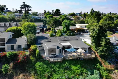 an aerial view of a house with yard swimming pool and outdoor seating