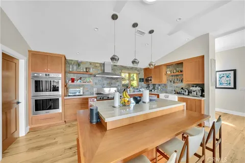 a view of a dining room kitchen counter top space and stainless steel appliances