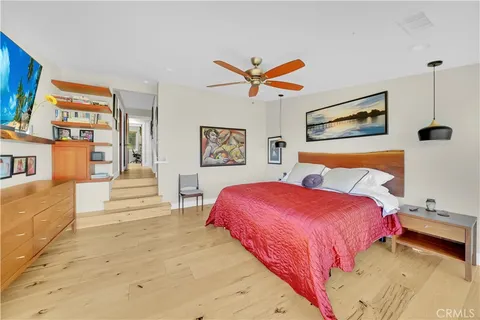 a bedroom with a large bed and a chandelier