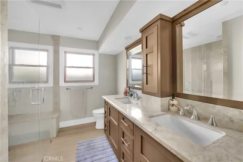 a bathroom with double vanity sinks and a mirror