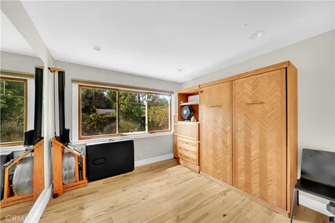 a room with a bed and a large window