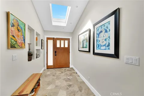 a view of a hallway with wooden floor and dining room