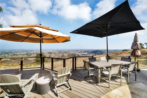 a view of a patio with furniture and umbrella