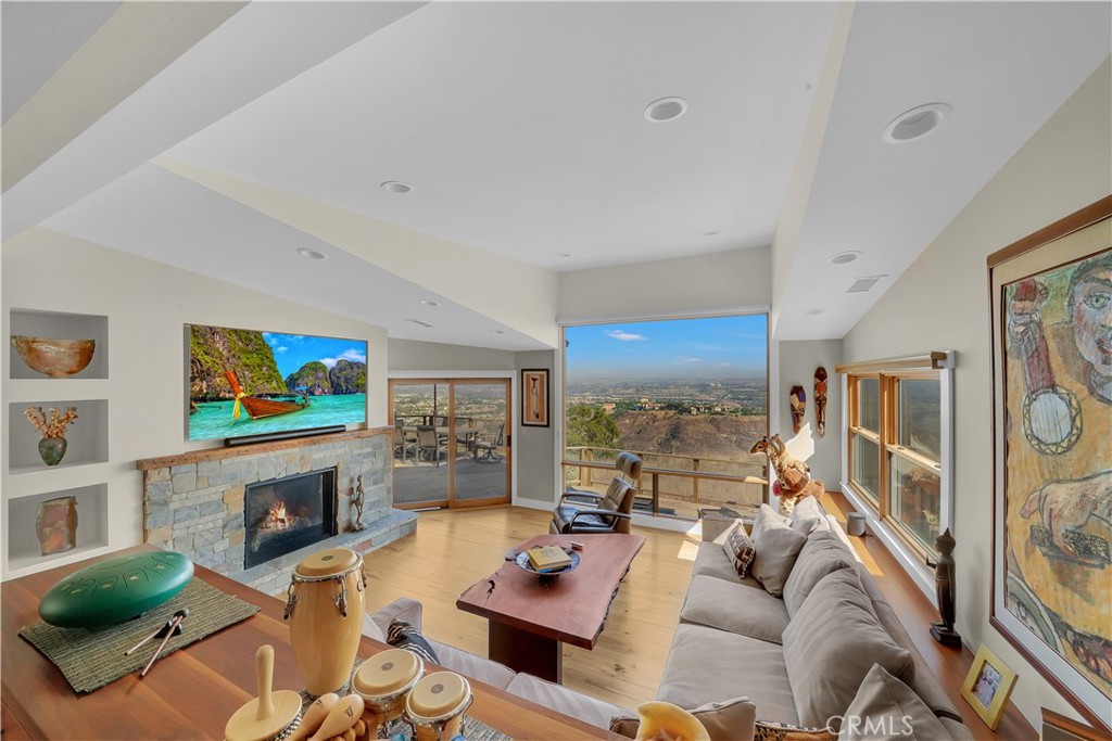 3064 Nestall Road Laguna Beach, CA 92651 - Photo 6 of 29 a living room with furniture a fireplace and a flat screen tv